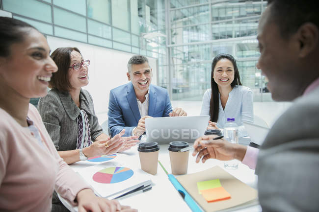 Happy business people laughing in meeting — Stock Photo