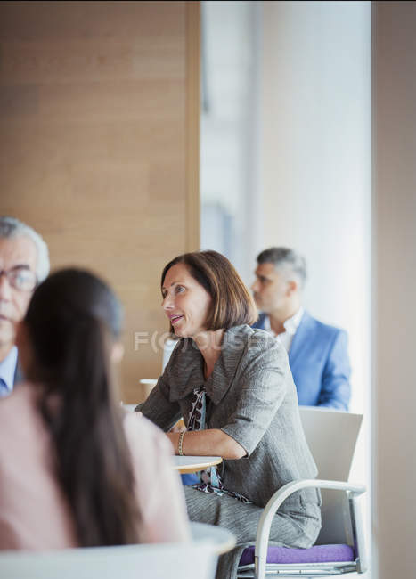 Businesswoman talking with colleagues — Stock Photo