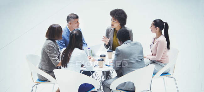 Business people talking at round table — Stock Photo