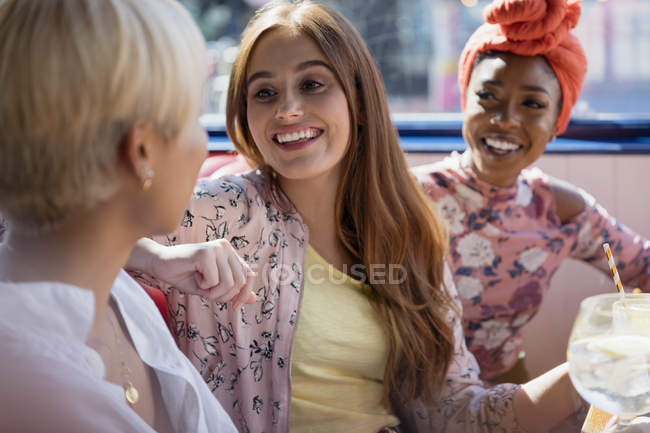 Young women friends talking in restaurant — Stock Photo