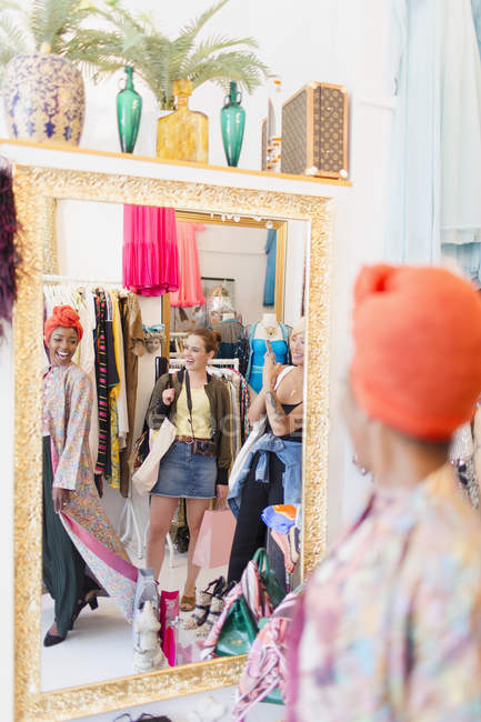 Young women friends shopping in clothing store — Stock Photo