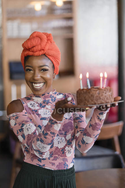 Portrait confident young woman carrying birthday cake — Stock Photo