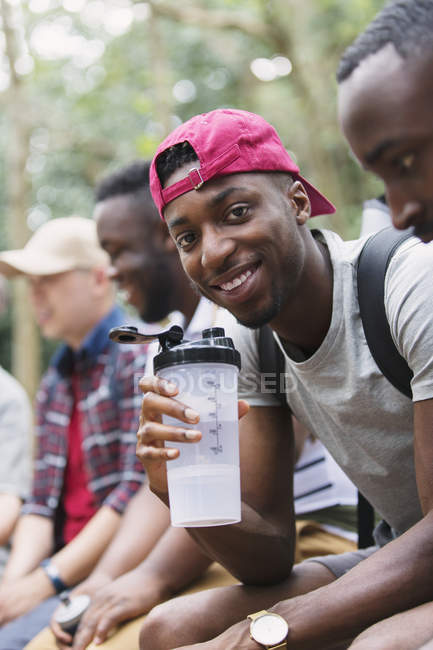 Portrait smiling man drinking water, preparing for hike — Stock Photo