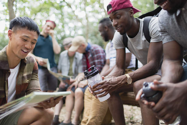 Men friends looking at hiking map in woods — Stock Photo