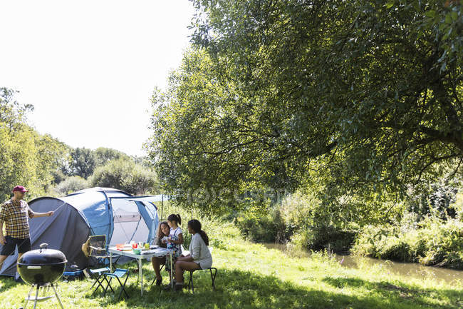Family at sunny campsite — Stock Photo