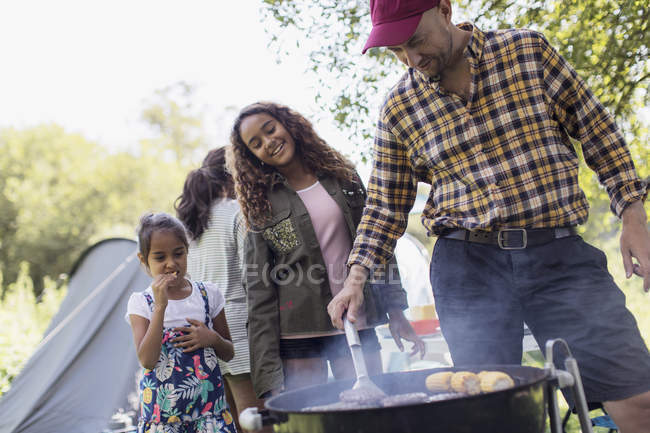 Family barbecuing at campsite — Stock Photo