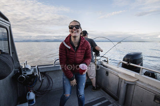 Portrait of enthusiastic woman on fishing boat — Stock Photo