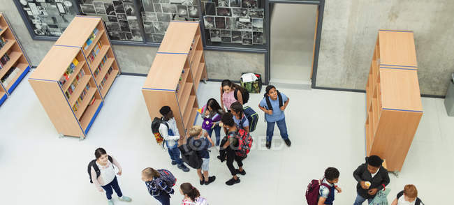 Junior high students in library — Stock Photo