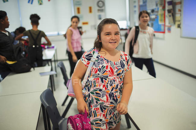 Portrait Of Confident Junior High School Student Leaving Classroom 