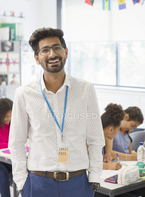 Portrait happy male teacher in classroom — Stock Photo