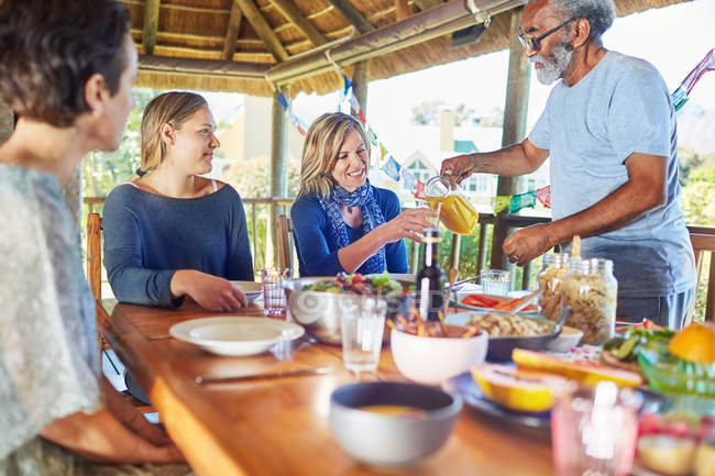 Friends enjoying healthy breakfast in hut during yoga retreat — Stock Photo