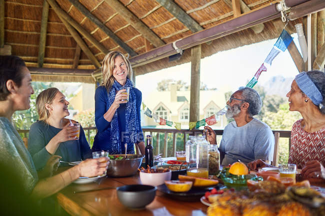 Friends enjoying healthy meal in hut during yoga retreat — Stock Photo