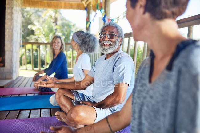 Homme âgé parlant avec la femme dans la cabane pendant la retraite de yoga — Photo de stock