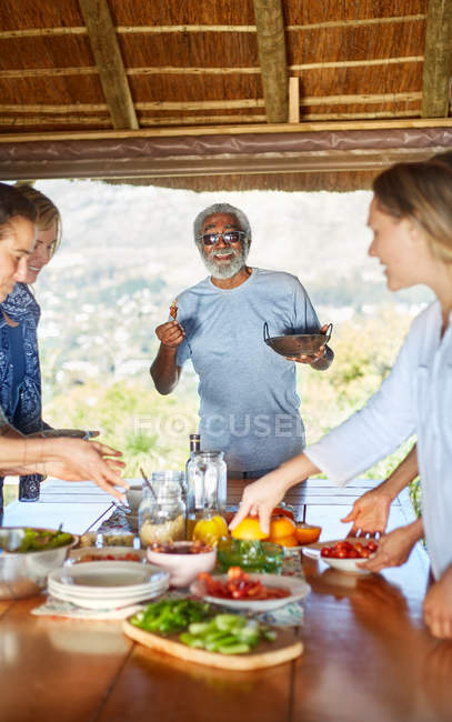 Amici che si godono un pasto sano in capanna durante il ritiro yoga — Foto stock