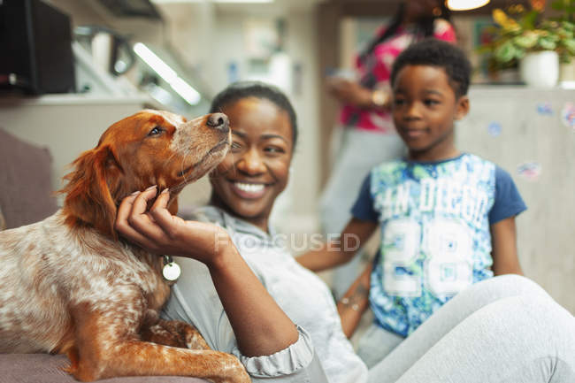 Mother and son petting dog — Stock Photo