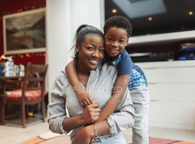 Portrait affectionate mother and son hugging — Stock Photo