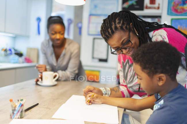 Grandmother and grandson coloring in kitchen — Stock Photo