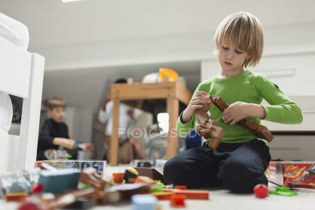 Curious boy assembling blocks — Stock Photo