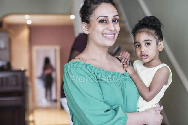 Portrait happy mother holding toddler daughter — Stock Photo