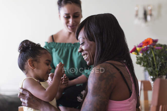 Lesbian couple playing with daughter — Stock Photo
