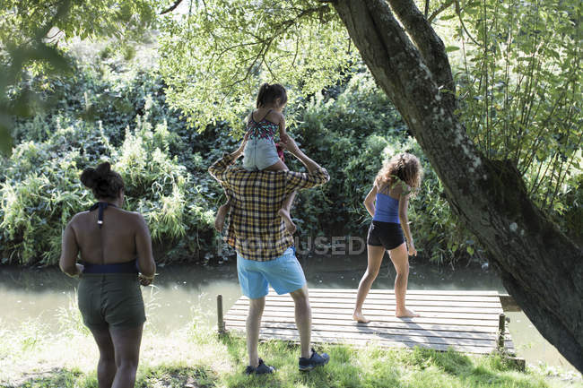 Family on dock at remote stream — Stock Photo