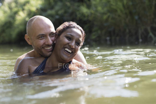 Счастливая, любящая пара в солнечной реке — стоковое фото