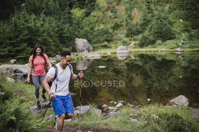 Coppia escursioni lungo il lago nel bosco — Foto stock