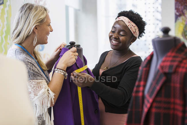 Female fashion designers working at dressmakers model — Stock Photo