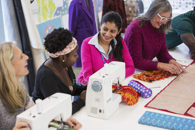 Fashion designers using sewing machines — Stock Photo