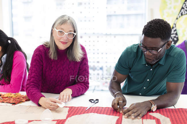Portrait confident female fashion designer preparing sewing pattern — Stock Photo