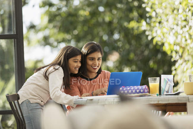 Мать и дочь с помощью ноутбука — стоковое фото
