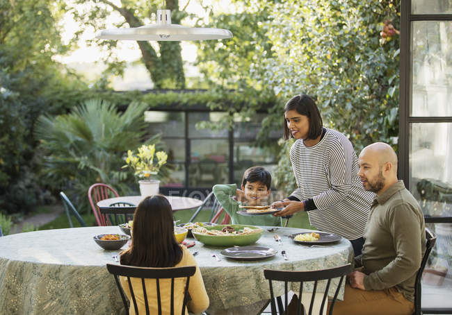 Family eating lunch at dining table — Stock Photo