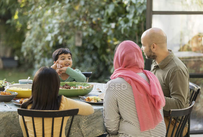 Family eating dinner at table — Stock Photo