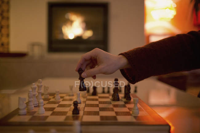 Hand playing chess, moving piece — Stock Photo