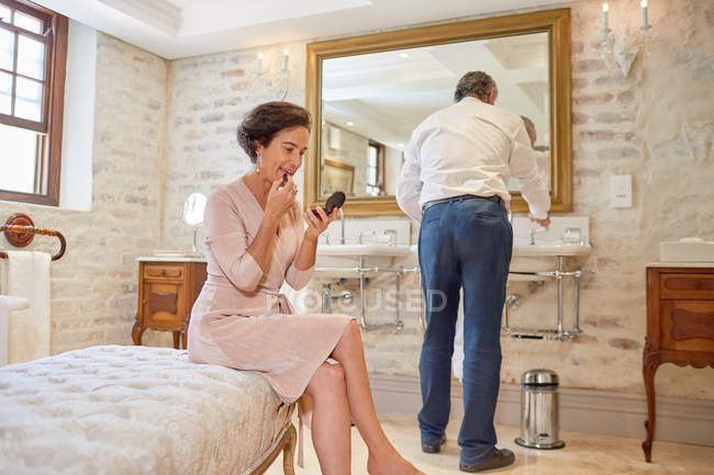 Couple preparing in hotel bathroom — Stock Photo