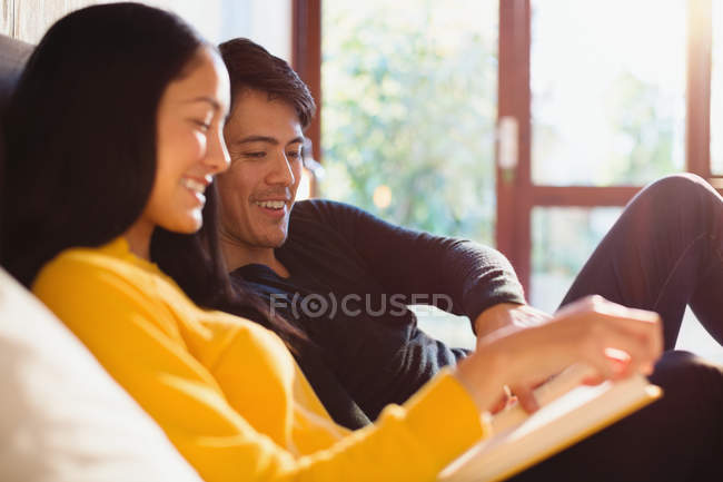 Couple reading book in bed — Stock Photo