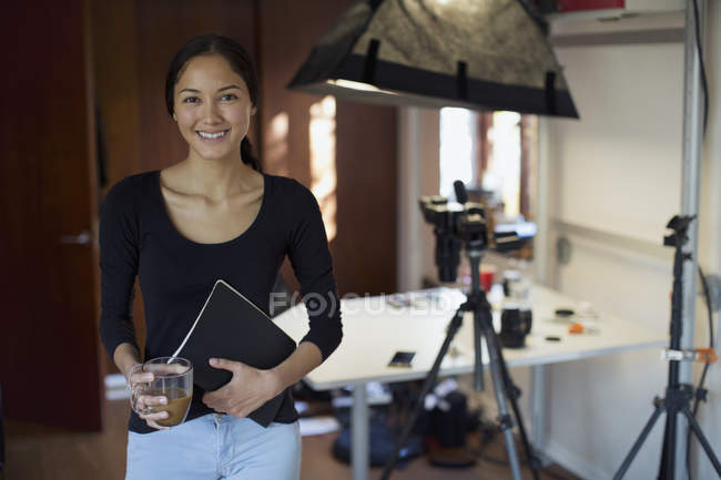 Portrait confident female photographer working in studio — Stock Photo