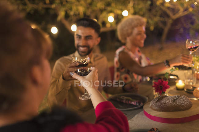 Friends toasting wine glasses at dinner garden party — Stock Photo