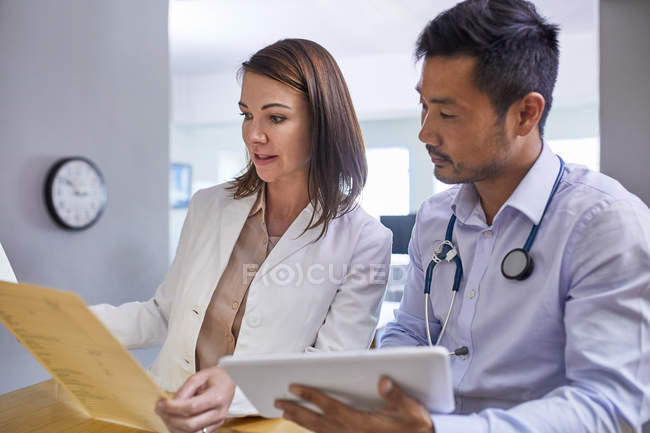 Doctors discussing medical record in clinic — Stock Photo