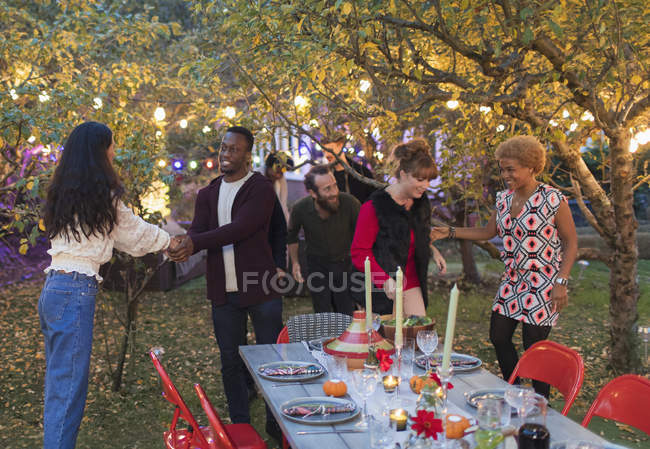 Friends talking at dinner garden party — Stock Photo