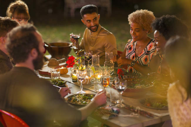 Друзья наслаждаются ужином в саду — стоковое фото