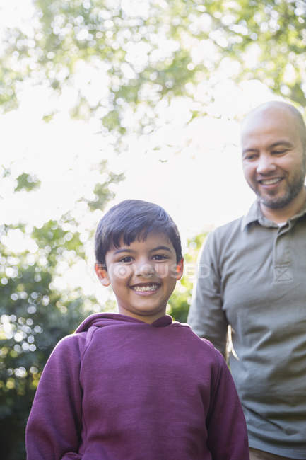 Portrait happy father and son in park — Stock Photo