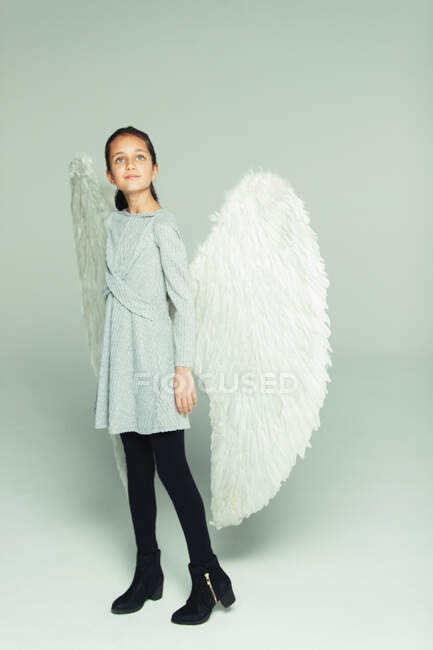 Portrait hopeful, ambitious girl wearing angel wings — Stock Photo