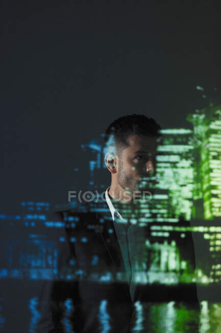 Double exposure thoughtful businessman against cityscape at night — Stock Photo