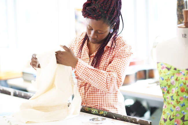 Жіночий дизайнер моди з тканиною в студії — стокове фото