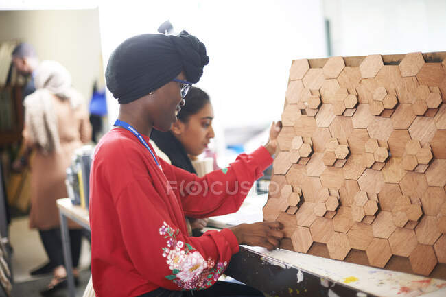 Female artist with 3D wood art in art studio — Stock Photo