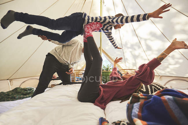 Playful family in camping yurt — Stock Photo