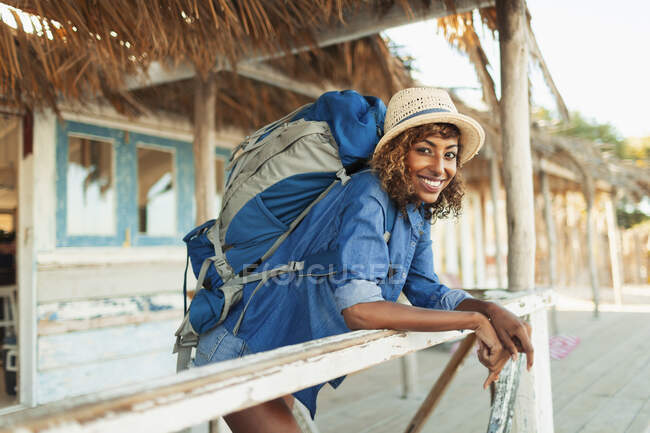Retrato feliz jovem mochileiro feminino na praia cabana pátio — Fotografia de Stock