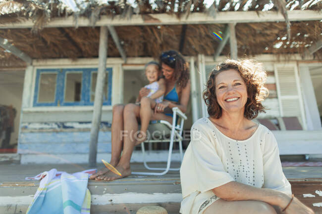 Portrait happy multi-generation women on beach hut patio — Stock Photo