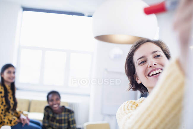Smiling, confident businesswoman leading meeting — Stock Photo